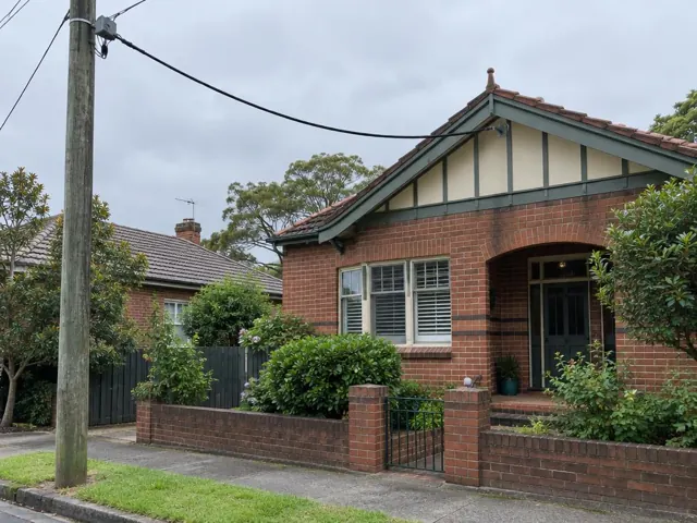 Brick house with overhead service cable attached near the gable in Hornsby